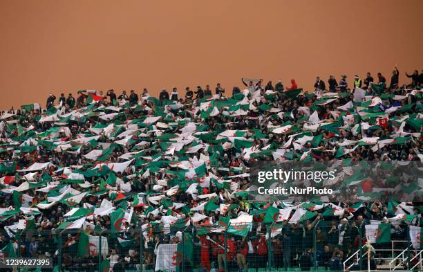 Algerian fans wave flags during the second leg of the African Qualifiers for the Qatar 2022 World Cup between Algeria and Cameroon at Mustapha...