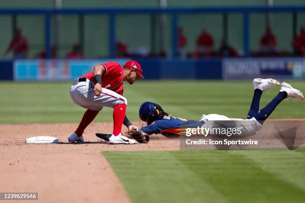 Washington Nationals second basemen Cesar Hernandez tags out Houston Astros left fielder Lewis Brinson during a Spring Training Baseball game between...