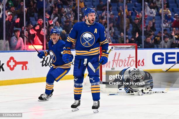 Zemgus Girgensons celebrates with Cody Eakin of the Buffalo Sabres after scoring a goal against Connor Hellebuyck of the Winnipeg Jets during an NHL...