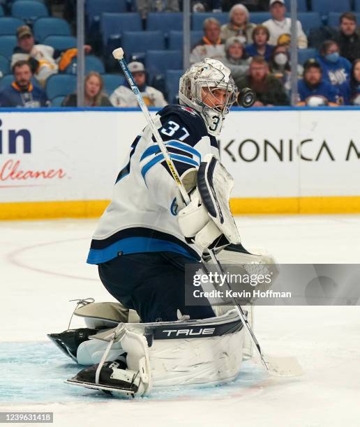 Connor Hellebuyck of the Winnipeg Jets makes the save against the Buffalo Sabres during the third period at KeyBank Center on March 30, 2022 in...