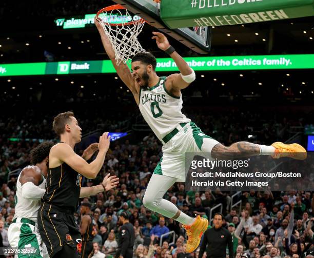 March 30: Jayson Tatum of the Boston Celtics hangs on the rim after dunking during the second half of the NBA game against the Miami Heat at the TD...