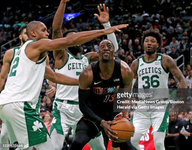 March 30: Al Horford of the Boston Celtics tries to stop Bam Adebayo of the Miami Heat from scoring as Marcus Smart looks on during the first half of...