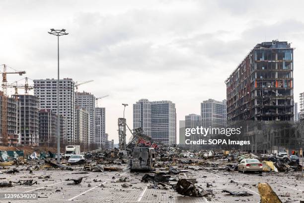 Devastating view of the parking lot with a burnt car near the destroyed Retroville shopping center following the Russian shelling attack. Retroville...