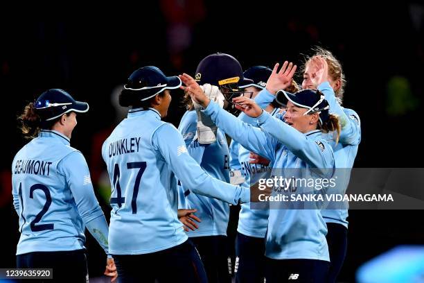 England players celebrate their victory in the 2022 Women's Cricket World Cup second semi-final match between England and South Africa at Haley Oval...