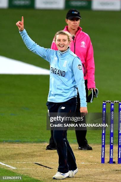 England's Charlie Dean celebrates the wicket of South Africa's Lara Goodall during the 2022 Women's Cricket World Cup second semi-final match between...