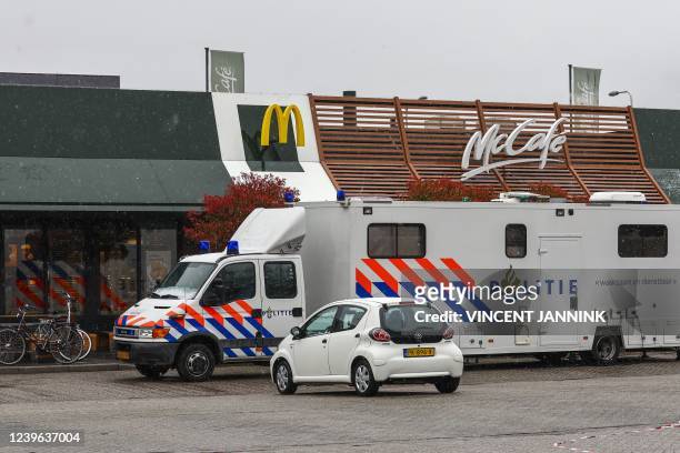 Police investigators are stationed outside a fast food McDonald's restaurant, the day after two people were shot and killed in the northern Dutch...