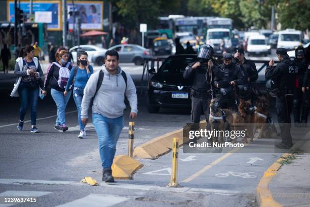 Security forces stand with police dogs as demonstrators protest in demand for jobs and better wages, in Buenos Aires, Argentina, March 30, 2022. In...