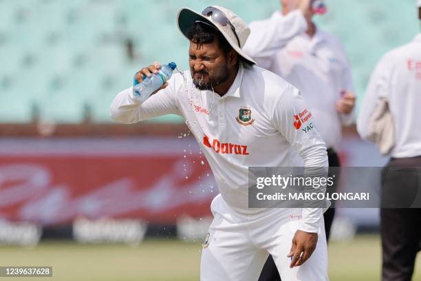 Bangladesh's Yasir Ali splashes water on his fave during a drinks break on the first day of the first Test cricket match between South Africa and...