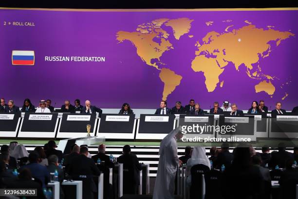 March 2022, Qatar, Doha: Soccer: FIFA Congress 2022. The flag of Russia can be seen on the screen while Fifa Secretary General Fatma Samoura reads...