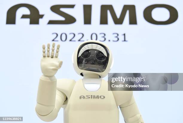 Honda Motor Co.'s ASIMO humanoid robot poses for a photo after its final performance in front of about 100 people at a showroom at the company's head...