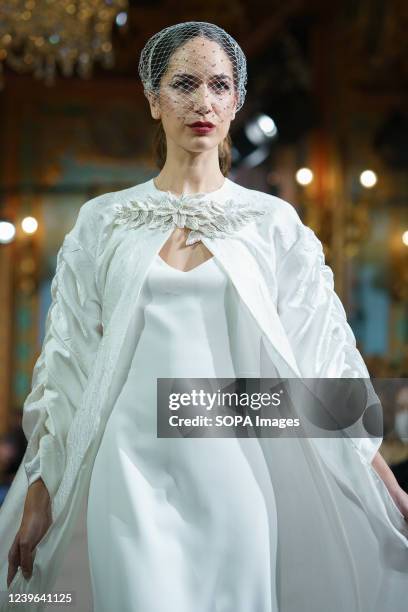 Model showcases Lorena Merino design during the Atelier Couture bridal catwalk within Madrid Fashion Week, held at the Santonia Palace in Madrid.