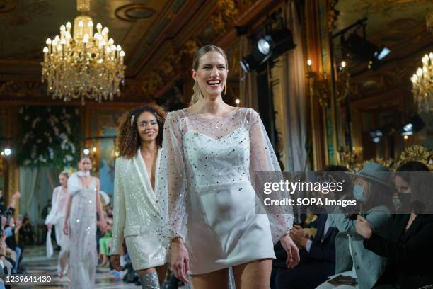 Models showcase Lorena Merino design during the Atelier Couture bridal catwalk within Madrid Fashion Week, held at the Santonia Palace in Madrid.