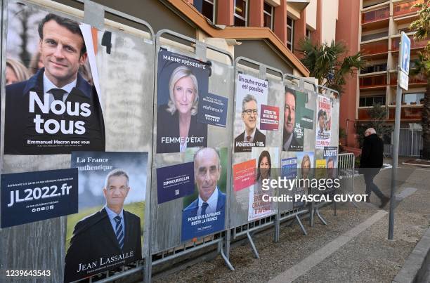 Picture taken on March 31, 2022 shows official posters of the presidential candidates in Montpellier. - March 28, 2022 marked the start of the...