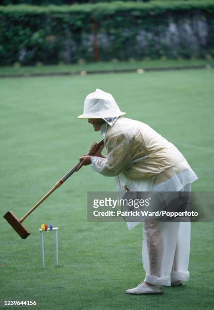 Woman playing croquet in the rain in Providence, Rhode Island, circa July 1992.