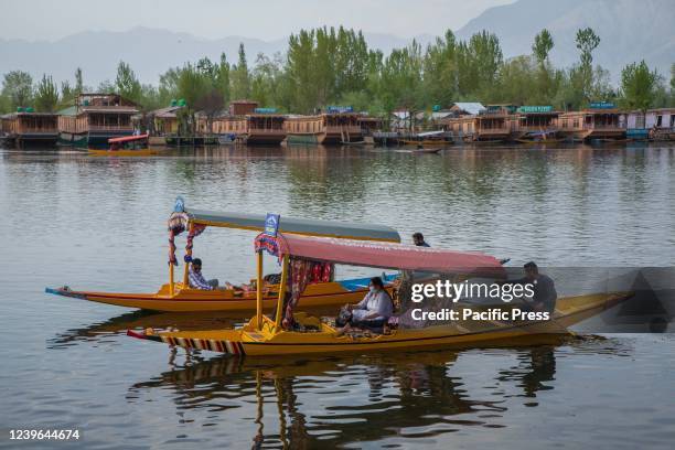 Indian tourists enjoying Shikara ride on the famous Dal lake in Srinagar.