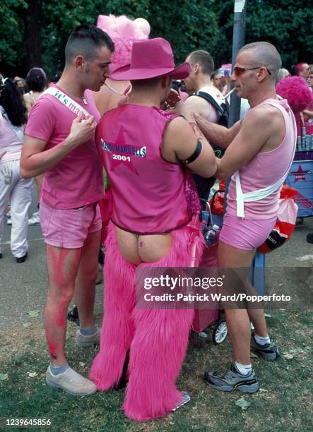 Men wearing a variety of pink costumes at a Gay Pride event in Hyde Park, London, circa July 2001.