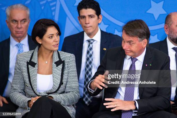 President of Brazil Jair Bolsonaro gestures next to First lady Michelle Bolsonaro during a farewell ceremony for outgoing ministers on March 31, 2022...