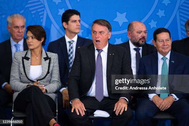 President of Brazil Jair Bolsonaro gestures next to First lady Michelle Bolsonaro and Vice President Hamilton Mourão during a farewell ceremony for...