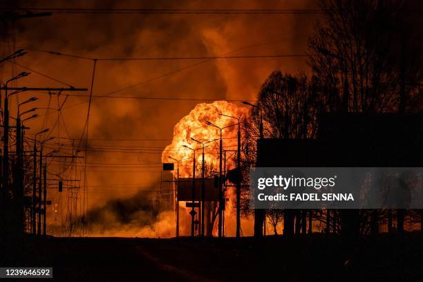 Gaz station burns after Russian attacks in the city of Kharkiv on March 30, 2022. - Russian forces are repositioning in Ukraine to strengthen their...