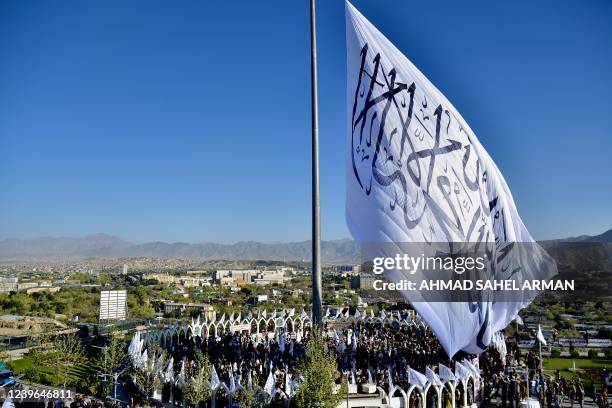 People gather at the venue for a flag hoisting ceremony of the Taliban flag on the Wazir Akbar Khan hill in Kabul on March 31, 2022.