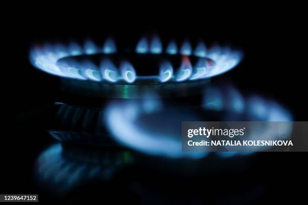 This photo illustration taken on March 31, 2022 in Moscow, shows gas burning on a domestic hob. - President Vladimir Putin on March 31 warned...