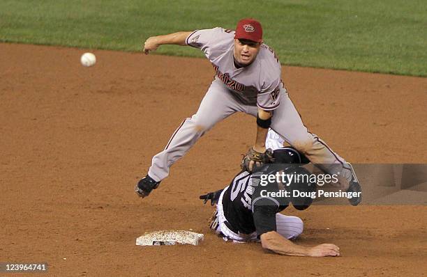 Shortstop John McDonald of the Arizona Diamondbacks gets a force out on Kevin Kouzmanoff of the Colorado Rockies but was unable to complete the...