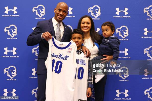 Shaheen Holloway holds up a jersey as poses with his wife Kim and sons Tyson and Xavier after he was introduced as the new Head Coach of the Seton...