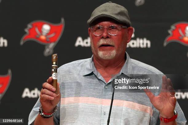 Former Head Coach Bruce Arians holds a cigar from a box his coaches bought him as a gift with his famous words on the cigar band "No risk it, no...