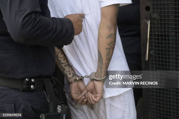 Man captured for alleged gang links is escorted by the National Civil Police during the state of emergency declared by the government in San Salvador...