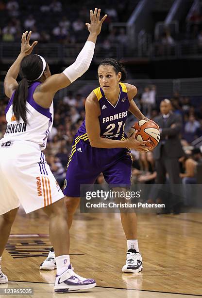 Ticha Penicheiro of the Los Angeles Sparks handles the ball during the WNBA game against the Phoenix Mercury at US Airways Center on September 3,...