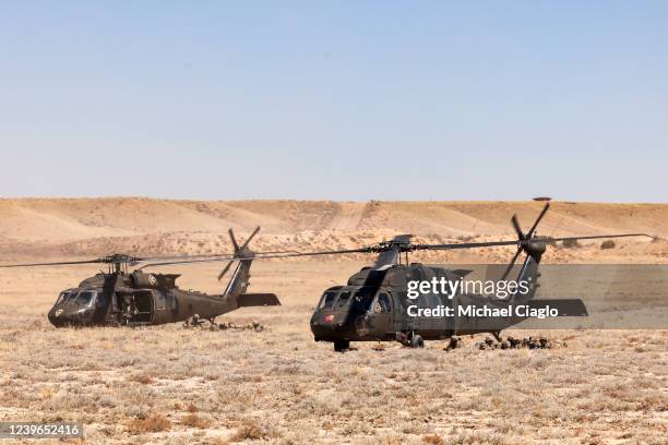 Cavalry scouts with the 2nd Stryker Brigade Combat Team exit a Blackhawk helicopter as they participate in Operation Steel Eagle on March 31, 2022 in...