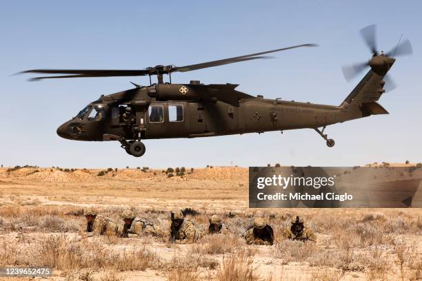 Cavalry scouts with the 2nd Stryker Brigade Combat Team wait as the Blackhawk helicopter that dropped them off for Operation Steel Eagle takes off on...