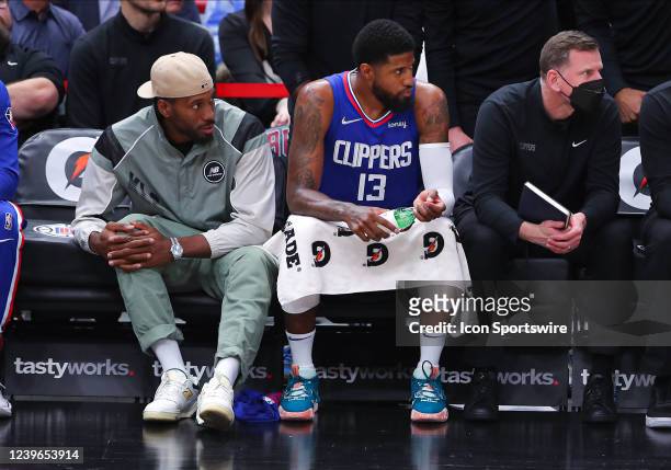 Los Angeles Clippers forward Kawhi Leonard and Los Angeles Clippers guard Paul George sit on the bench during a NBA game between the Los Angeles...