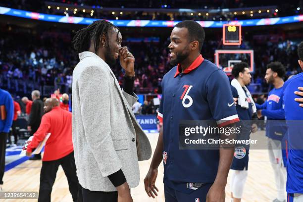 Jerami Grant of the Detroit Pistons talks to Paul Millsap of the Philadelphia 76ers after the game on March 31, 2022 at Little Caesars Arena in...