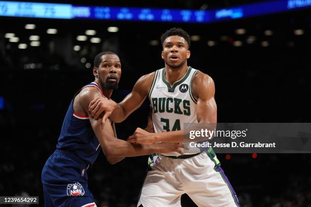 Kevin Durant of the Brooklyn Nets and Giannis Antetokounmpo of the Milwaukee Bucks fight for position during a game on March 31, 2022 at Barclays...