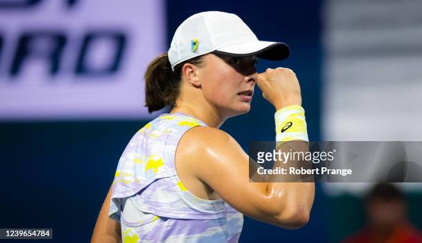 Iga Swiatek of Poland celebrates winning a point against Jessica Pegula of the United States in her semi-final match on day 11 of the Miami Open at...