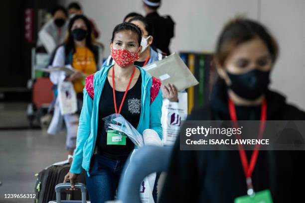 Passengers arrive at the Hong Kong International Airport on April 1 after the city lifted a flight ban on nine countries amid the pandemic.