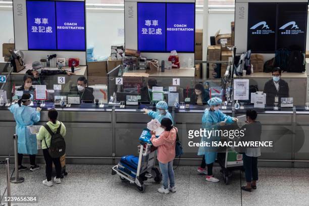 Passengers register to be taken to hotel quarantine at the Hong Kong International Airport on April 1 after the city lifted a flight ban on nine...
