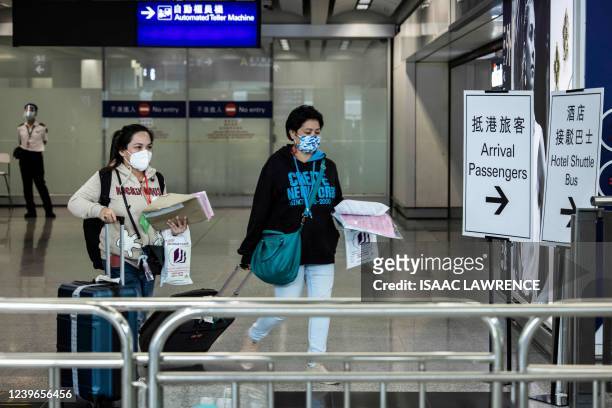 Passengers arrive at the Hong Kong International Airport on April 1 after the city lifted a flight ban on nine countries amid the pandemic.