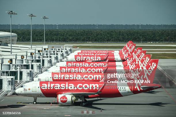 AirAsia aircraft are pictured on the tarmac at Kuala Lumpur International Airport 2 , as Malaysia reopened its borders for travellers fully...