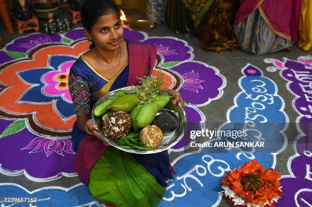 Students wearing traditional costumes celebrate on the eve of 'Ugadi' festival, or new year's day as per the Hindu lunisolar calendar, in Chennai on...