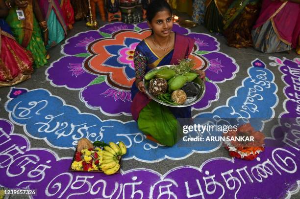 Students wearing traditional costumes celebrate on the eve of 'Ugadi' festival, or new year's day as per the Hindu lunisolar calendar, in Chennai on...