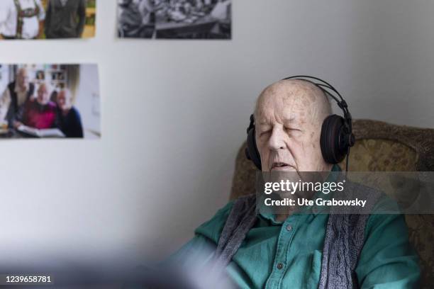 In this photo illustration an old man witk dementia enjoys music on March 30, 2022 in Heidelberg, Germany.