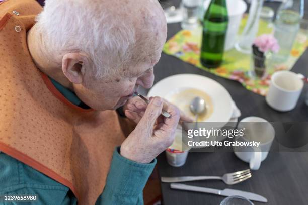 In this photo illustration an old man in nursing home loeffs a dessert on March 30, 2022 in Heidelberg, Germany.