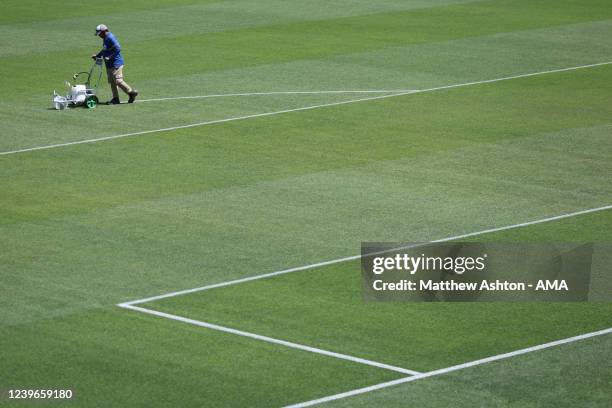 Groundsman is seen painting the lines on the pitch at the Stadium 974 a host venue for the Qatar 2022 FIFA World Cup in Doha. Built on the shore of...