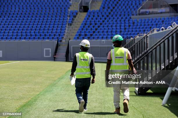 General internal view of the Stadium 974 as workers are seen pitch side preparing, a host venue for the Qatar 2022 FIFA World Cup in Doha. Built on...