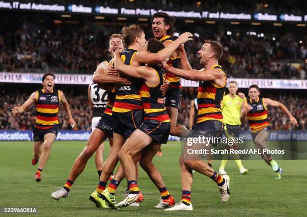 Players surround Jordan Dawson of the Crows after kicking the winning goal during the 2022 AFL Round 03 match between the Adelaide Crows and the Port...