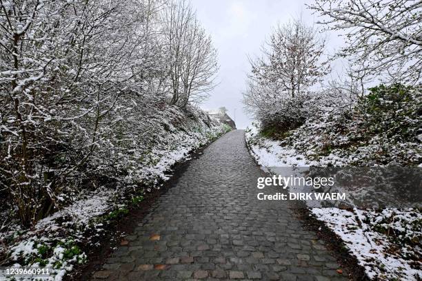 Photograph taken on April 1, 2022 shows snow at a cobblestone sector of route of the Ronde van Vlaanderen - Tour des Flandres one-day cycling race. -...
