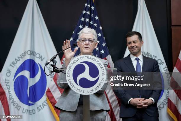 Secretary of Transportation Pete Buttigieg looks on as White House National Climate Advisor Gina McCarthy speaks during an event about fuel economy...