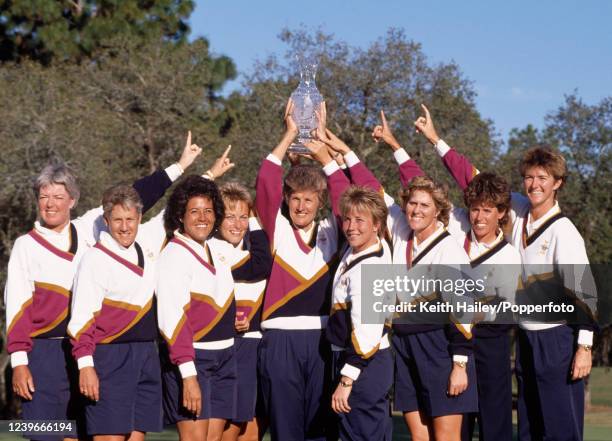 Team United States captain Kathy Whitworth and her team celebrate with the trophy after winning the Solheim Cup at Lake Nona Golf & Country Club on...